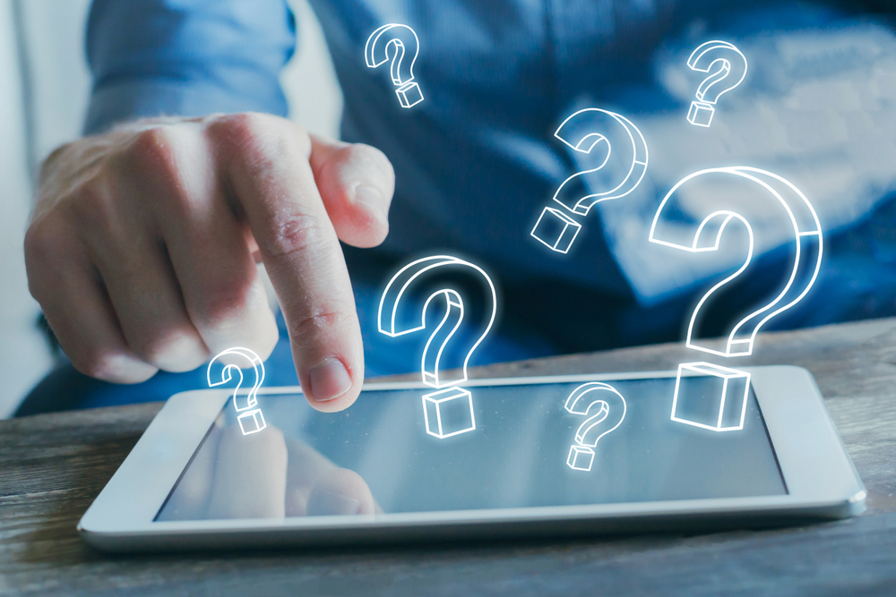 Many,Quiestion,Marks,From,The,Screen,Of,Tablet,Computer,,Find Tablet with hovering question marks